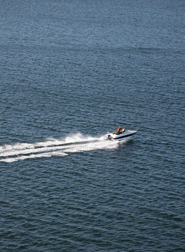 Small boat with two people on a body of water